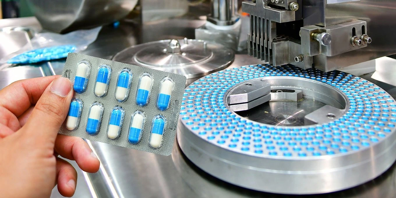 Picture of a package of pills and the machine producing it.